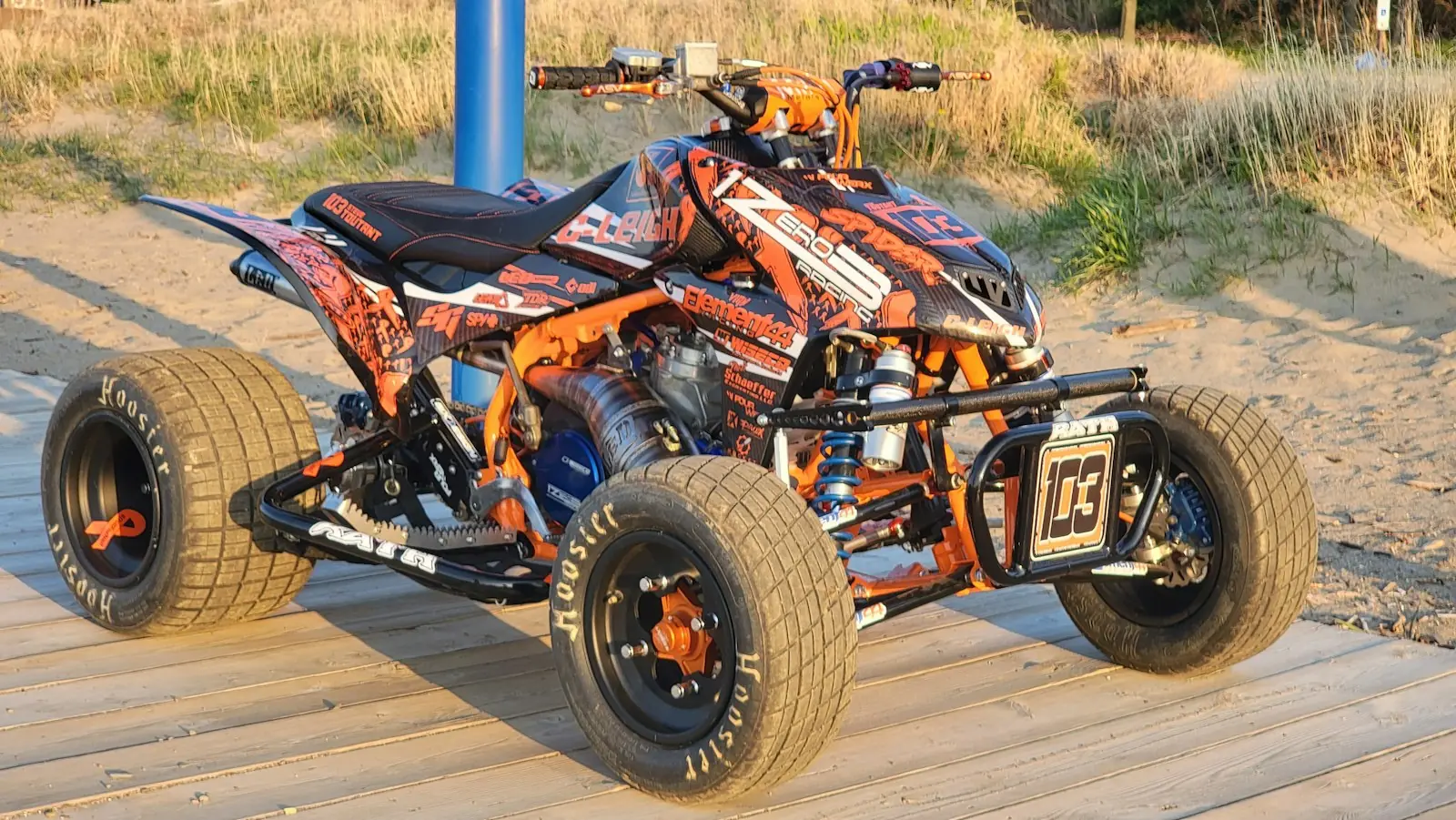 Orange and black ATV standing on a wooden floor