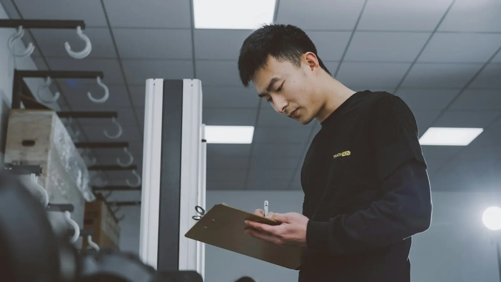 Inspector with a clipboard checking goods in a factory